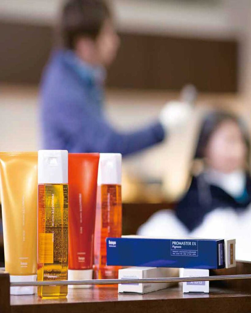Exclusive stylist applying Hoyu Professional products to client